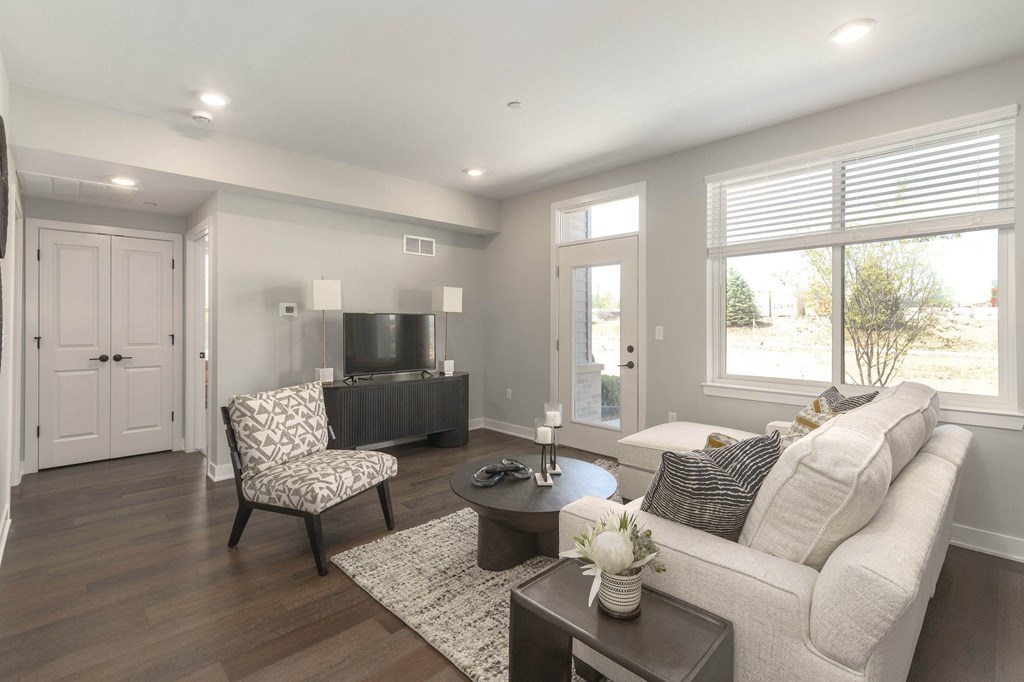 a living room with a white couch and a tv